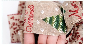 Detail of Christmas ribbon with Merry Christmas text, trees, and rustic linen texture