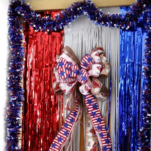 Independence Day decoration set with star-spangled bow and red white blue tinsel curtains