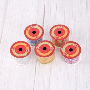 Detail of Christmas ribbons with gold star patterns in red, gold, blue, and silver