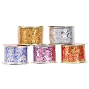 Five rolls of colorful Christmas ribbons with gold star and snowflake patterns on white backdrop