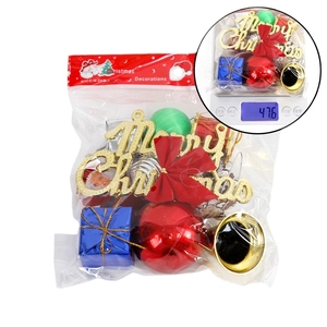 Christmas decoration set with gold Merry Christmas sign, red bows, and bells in a package