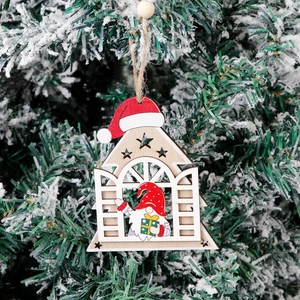 Wooden Christmas gnome house ornament hanging on a snowy pine tree branch for decor