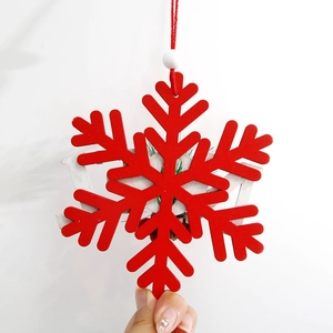 Handheld double-layer red wooden snowflake ornament with white lettering for Christmas decor