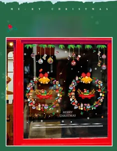 Detail of Christmas wreath window clings with ribbons, bells and festive stockings