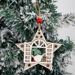 Star-shaped wooden Christmas gnome ornament with festive green hat on snowy tree branch