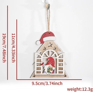 Detail of wooden Christmas gnome ornament with red hat and laser-cut cabin design