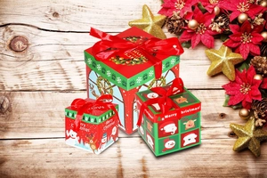 Three-piece set of red and green Christmas gift boxes with ribbons and festive illustrations