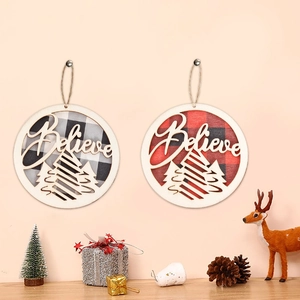 Detail of wooden Believe Christmas ornaments with red and white plaid fabric patterns