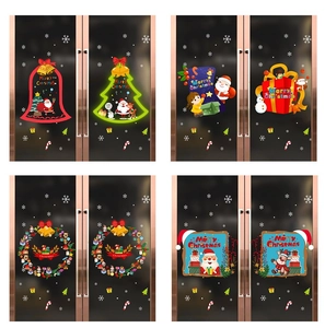 Detail of Christmas window clings featuring Santa, reindeer and snowman on glass