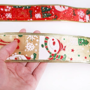 Close-up of red and champagne Christmas ribbons with golden edges and festive prints