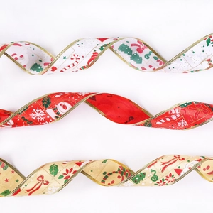 Close-up of festive Christmas ribbons with gold edges and holiday character prints