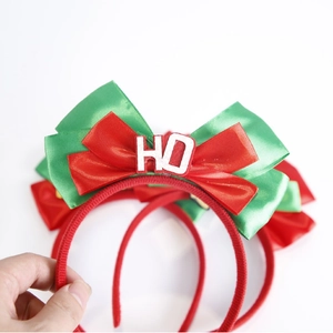 Festive Christmas headband with layered red and green satin bows and HO metal detail