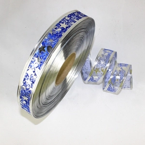 Detail of 25mm blue Christmas ribbon with silver stars pattern and metallic edges