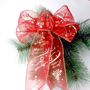 Red sheer organza Christmas bow with golden Merry Christmas print on pine branch
