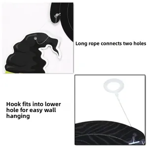 Close-up of Halloween spiral decoration assembly with black cardstock and plastic hooks