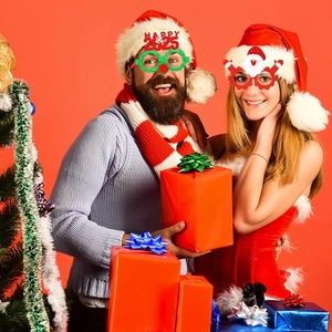 Close-up of festive Happy 2025 and Santa Claus glasses for holiday party photo props