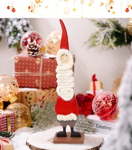 Detail of wooden Santa figurine with white wool beard on a festive holiday background