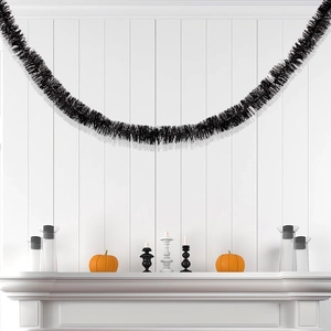 Detail of 2m black tinsel garland draped over fireplace for Halloween home decor