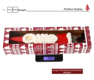 Detailed view of large felt Santa doll in gift box packaging on weight scale