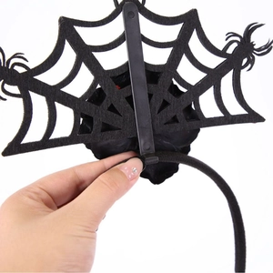 Halloween headband with black spider web design and a rose for festive costume parties