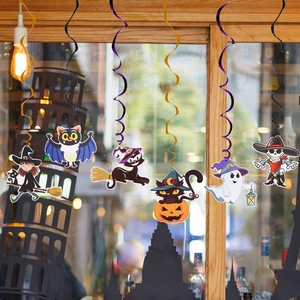Detail of hanging Halloween swirl decorations featuring cartoon witch and ghost paper cutouts
