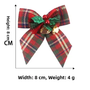 Close-up of a Christmas plaid bow with holly leaves, red berries and gold bells