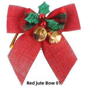 Detail of red burlap Christmas bow featuring golden bells, green holly leaves and berries