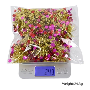 Close-up of 2m Christmas star tinsel weight measurement on a scale for festive decor