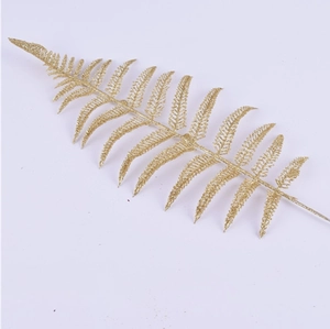 Detail of golden artificial fern leaf with glitter coating for Christmas tree decoration