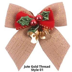 Detail of Christmas burlap bow with gold thread, red berries, and golden metal bells