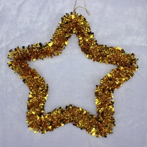 Close-up of a decorative golden tinsel star ornament for Christmas tree festive decor