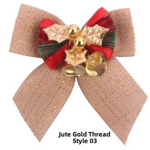 Close-up of burlap Christmas bow with gold bells and holly leaves ornament