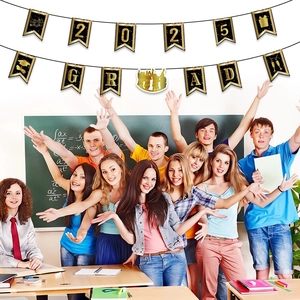 Close-up of 2025 Graduation banner with black swallowtail flags and gold GRAD printing