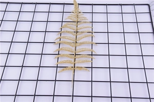 Detail of a gold glitter artificial Persian leaf for Christmas tree decoration