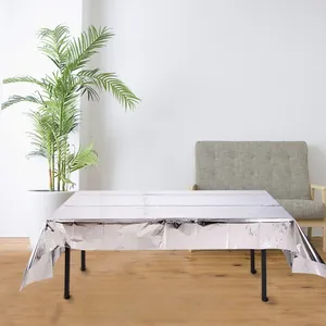 Close-up of shiny silver foil disposable tablecloth with industrial metallic texture