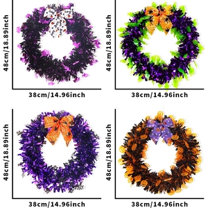Detail of four Halloween wreaths with tinsel and bows in ghost and pumpkin designs