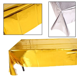 Detailed macro view showing the shiny metallic texture of gold and silver foil tablecloths