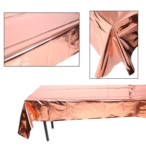Close-up of rose gold metallic foil tablecloth showing shiny reflective texture and drape