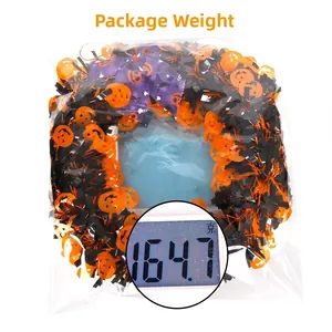 Halloween wreath with pumpkin sequins and bow shown on a scale weighing 164.7g