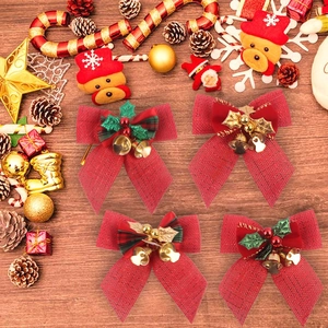 Christmas bow set with red berries, pine cones and gold bells on rustic wooden background