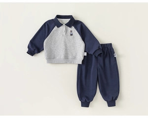Detailed view of kids' cotton tracksuit with polo collar and cute bear embroidery on top