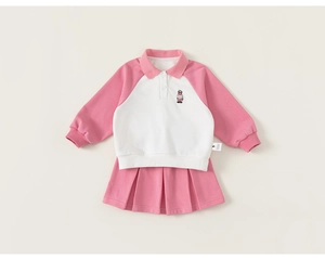 Detail of girls' polo sweatshirt with bear embroidery and pink pleated skirt set