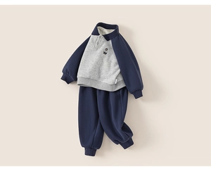 Detailed close-up of girls' polo sweatshirt with bear embroidery and matching navy pants