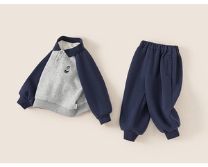 Detail of kids fleece tracksuit featuring embroidered bear patch and ribbed cuffs