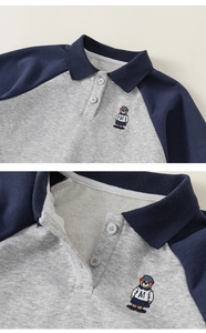 Close-up of bear embroidery and navy collar on grey polo sweatshirt for girls