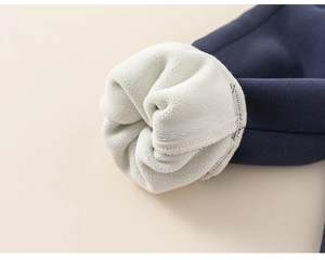 Detail shot of navy blue fabric with thick white fleece lining for superior warmth