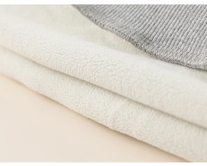 Close-up of thick white fleece lining and grey ribbed knit cuffs on kids warm tracksuit