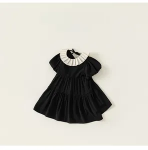 Detail of vintage style white ruffled collar and bubble sleeve on girls black dress