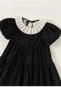 Detailed view of the vintage white ruffle collar and puff sleeves on the black girl dress