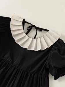 Elegant girls black puff sleeve dress with white ruffled collar and back tie detail